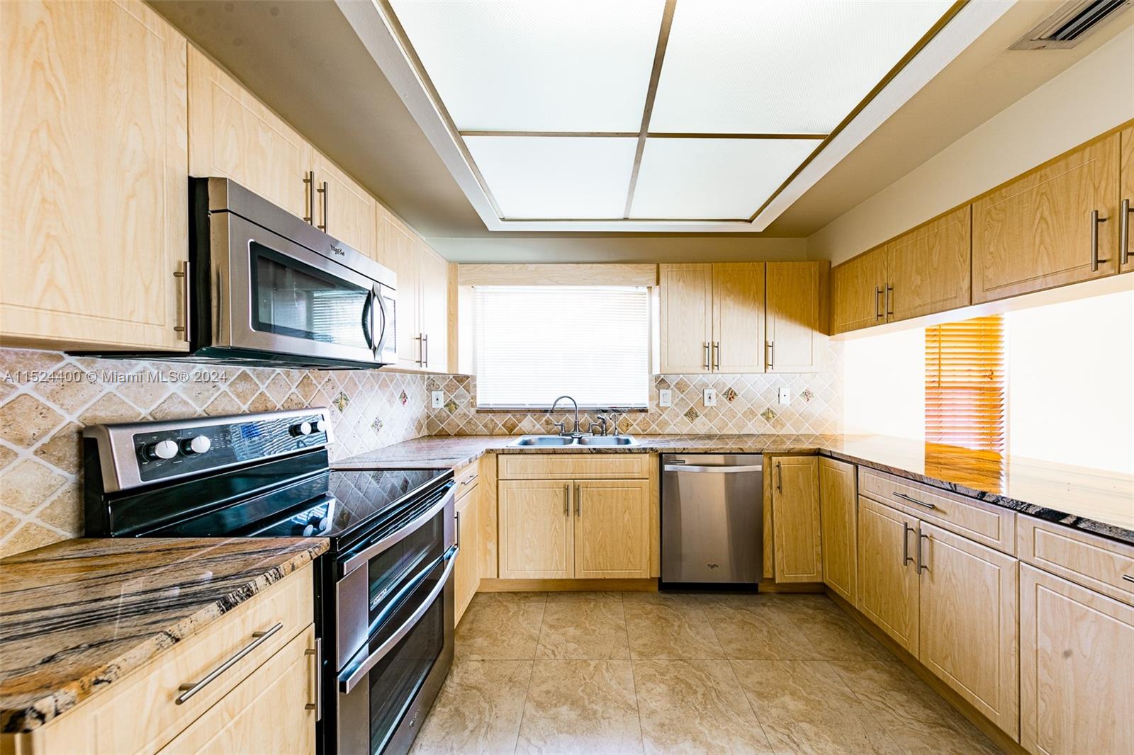 10448 Southwest 23rd Street Miami, FL 33165 - Photo 13 of 35 a kitchen with stainless steel appliances granite countertop a stove a sink and a microwave