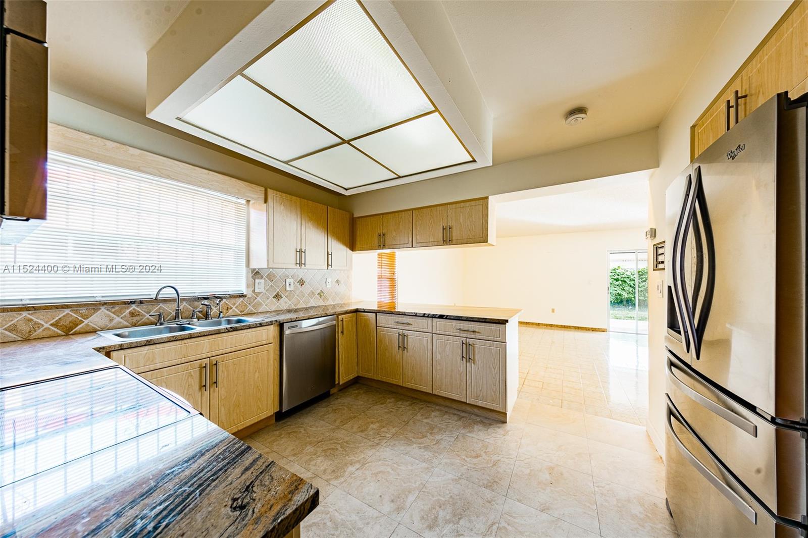 10448 Southwest 23rd Street Miami, FL 33165 - Photo 14 of 35 a kitchen with a refrigerator sink and stove top oven