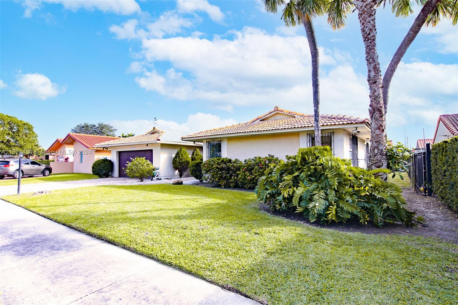 10448 Southwest 23rd Street Miami, FL 33165 - Photo 2 of 35 a front view of a house with garden
