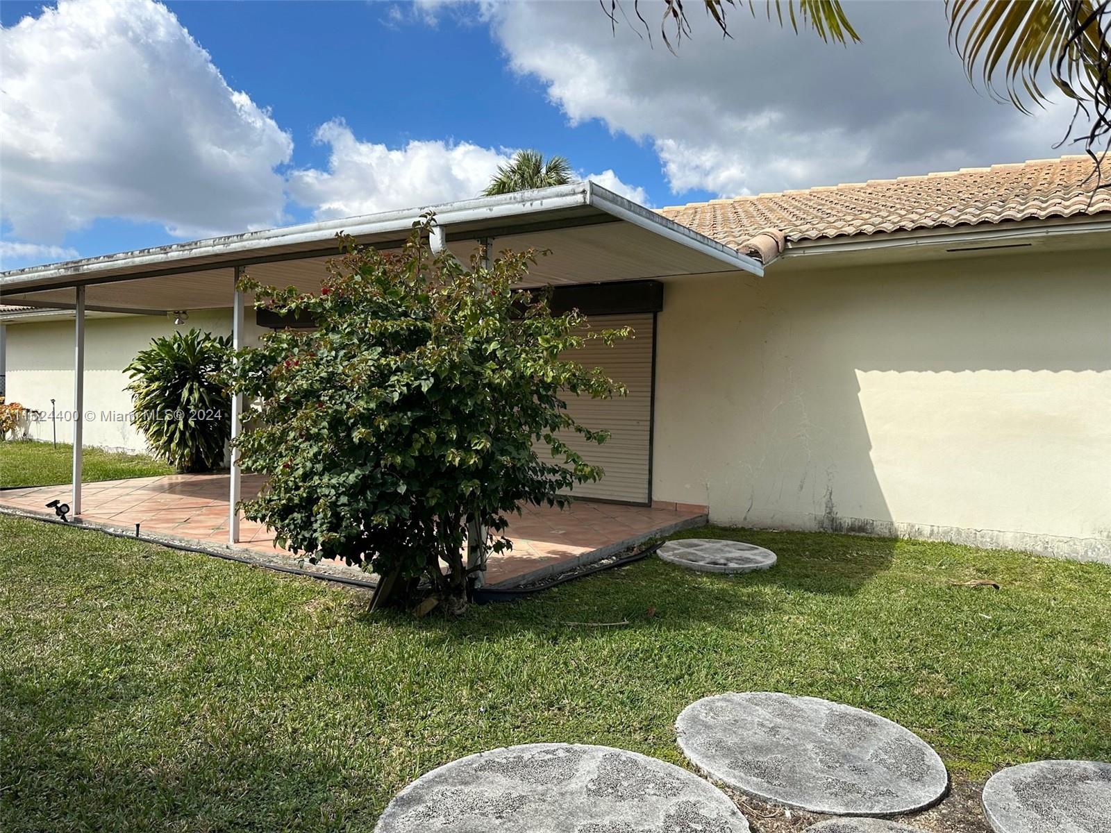 10448 Southwest 23rd Street Miami, FL 33165 - Photo 27 of 35 a view of a backyard with plants and a patio