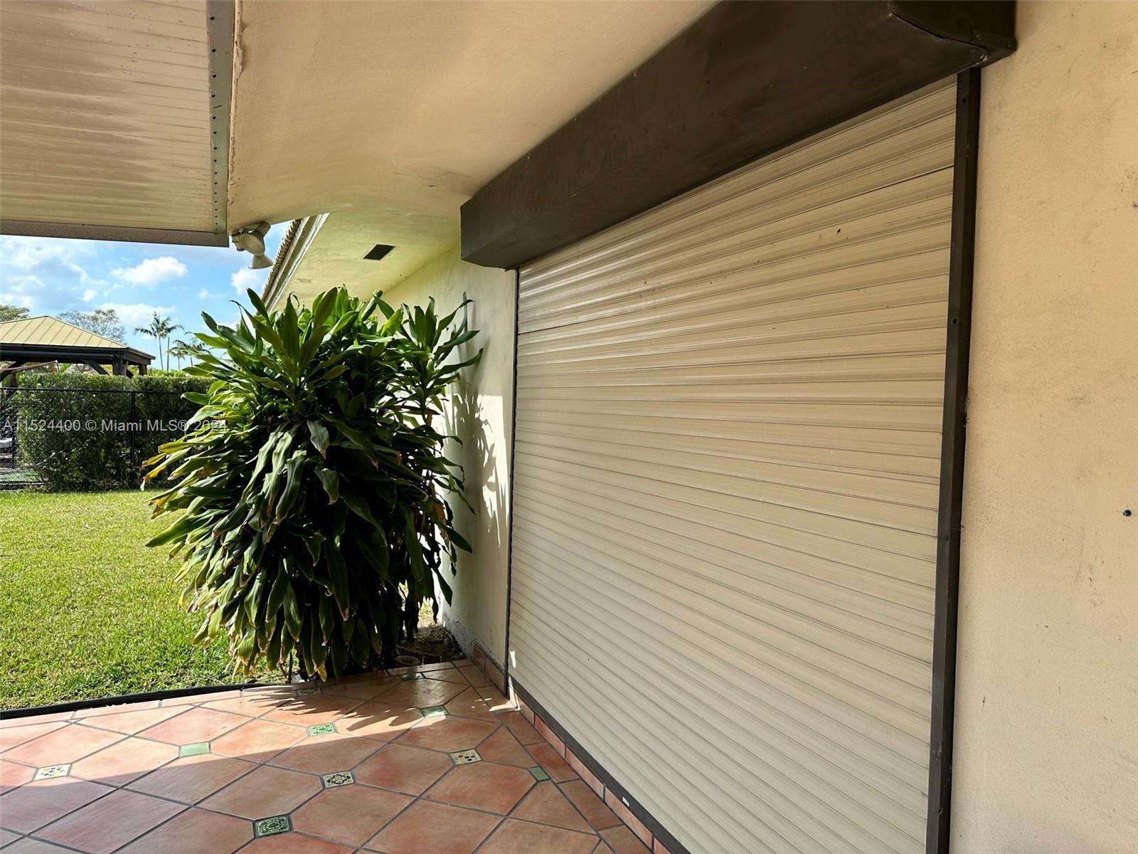 10448 Southwest 23rd Street Miami, FL 33165 - Photo 29 of 35 a potted plant sitting in front of a door