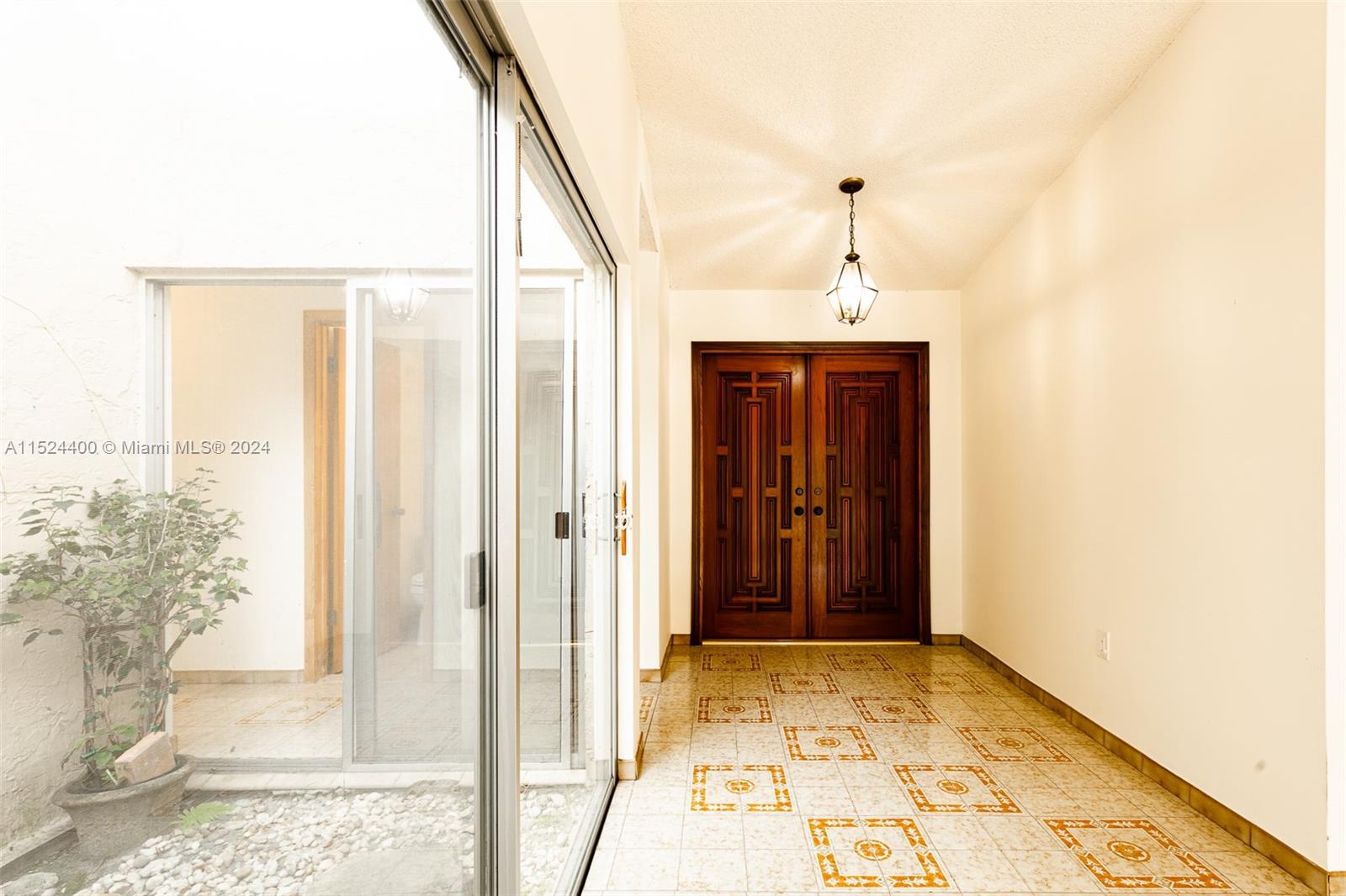 10448 Southwest 23rd Street Miami, FL 33165 - Photo 7 of 35 a view of a hallway with wooden floor and a living room