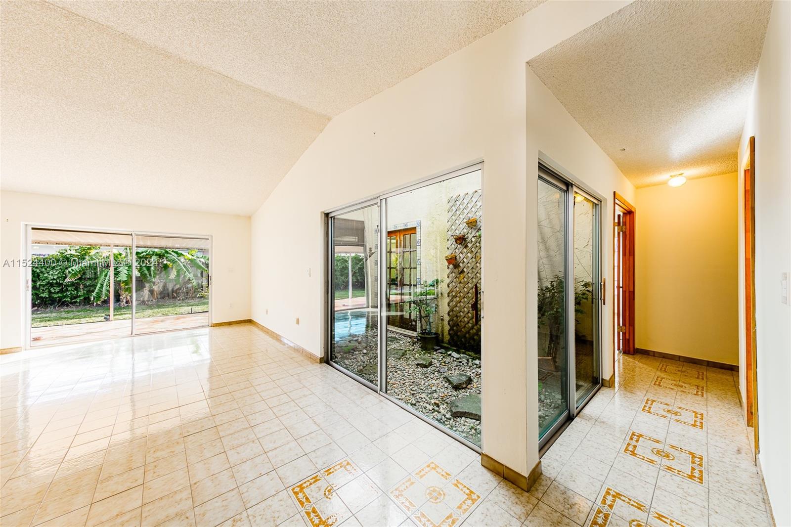 10448 Southwest 23rd Street Miami, FL 33165 - Photo 9 of 35 a view of a hallway with wooden floor and furniture