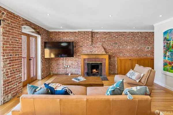 a living room with fireplace furniture and a flat screen tv