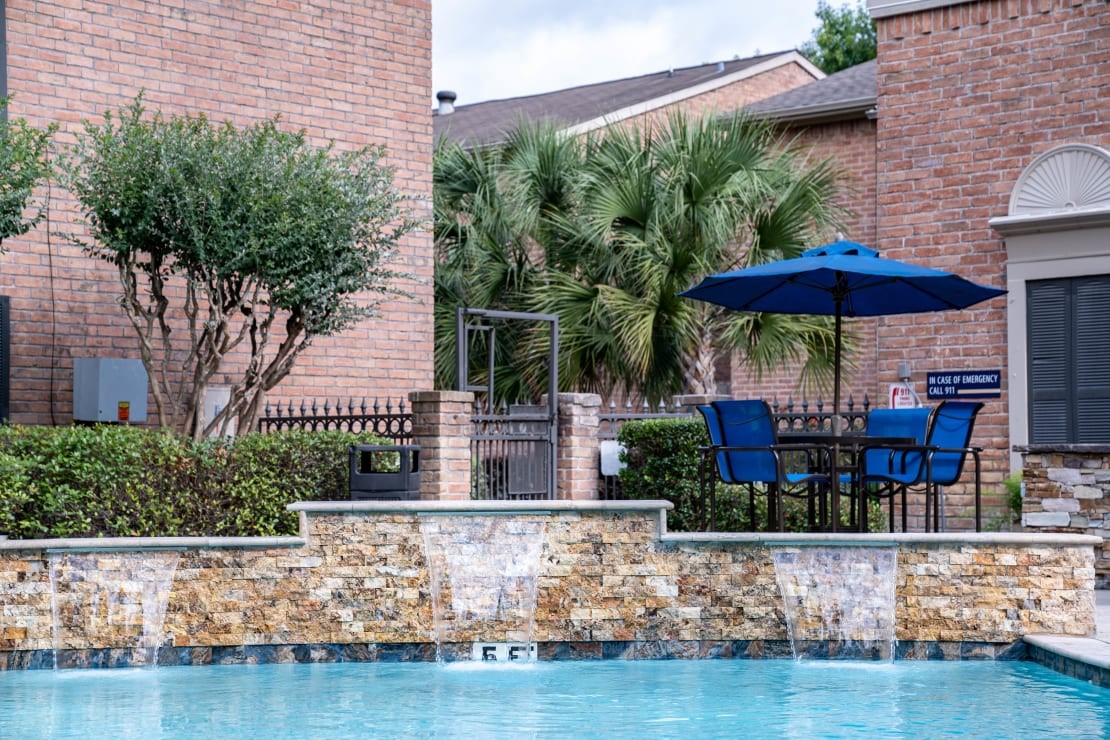 2800 South Ashford Road, Unit 306 Houston, TX 77082 - Photo 14 of 35 a view of a chairs and table in the patio with a swimming pool
