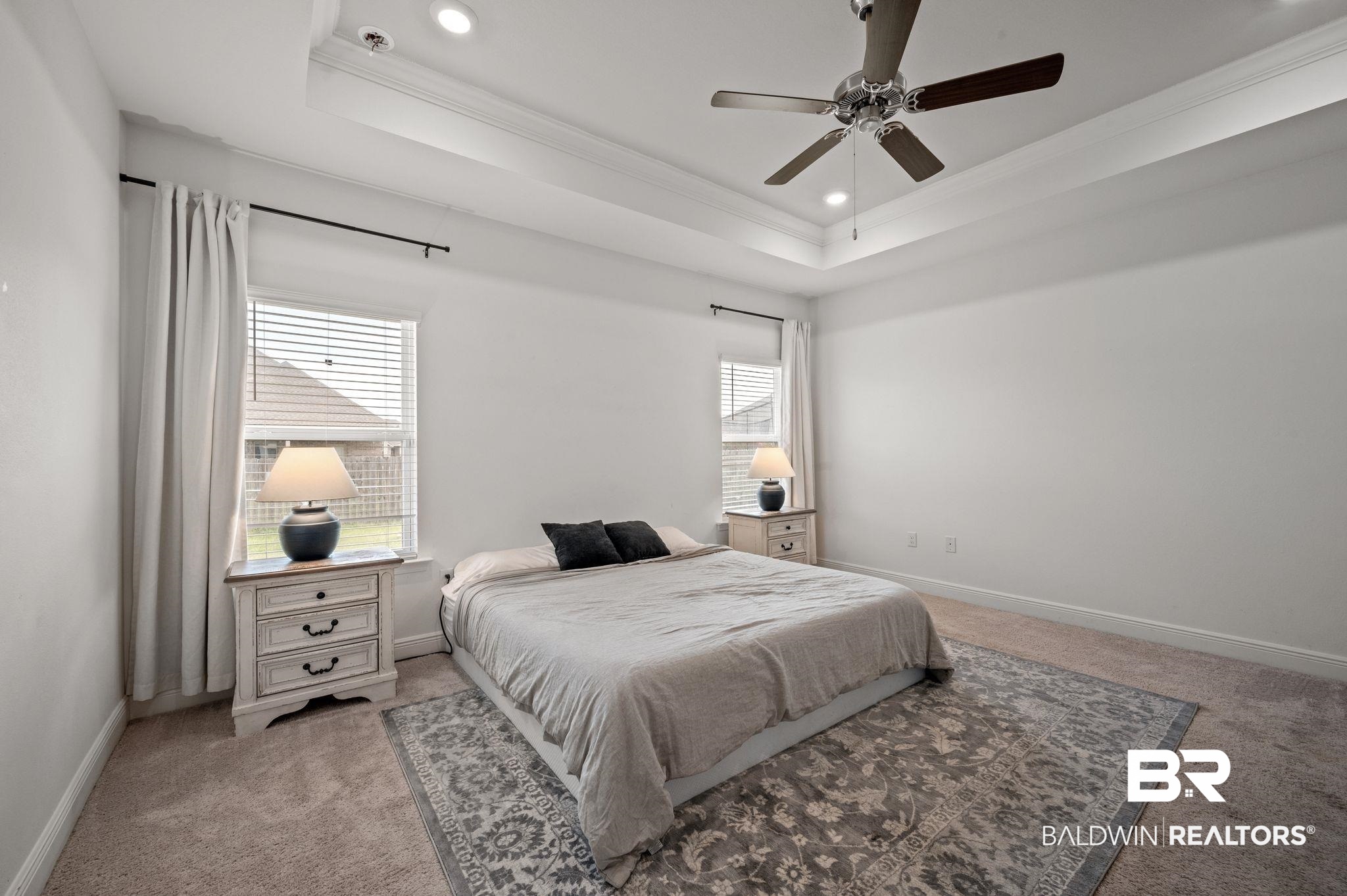 10169 Dunleith Loop Daphne, AL 36526 - Photo 32 of 40 Bedroom with ornamental molding, light carpet, a tray ceiling, recessed lighting, and a ceiling fan
