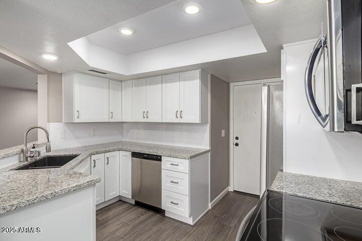 3030 North Hayden Road, Unit 16 Scottsdale, AZ 85251 - Photo 4 of 30 a kitchen with granite countertop white cabinets and a sink