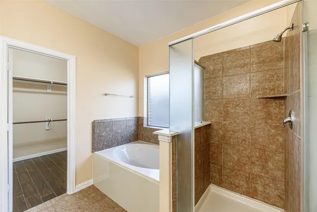 a bathroom with a tub and shower