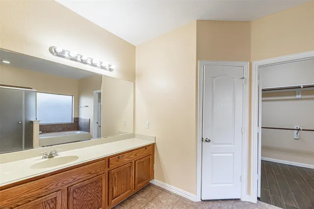 a bathroom with a double vanity sink and a mirror