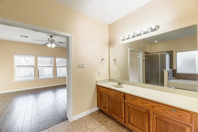 a spacious bathroom with a double vanity sink and a mirror