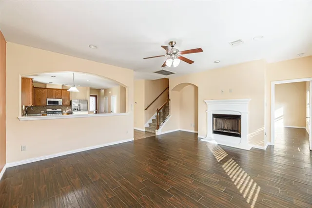 a view of a livingroom with wooden floor and a fireplace