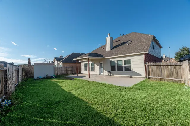 a front view of a house with a garden and yard