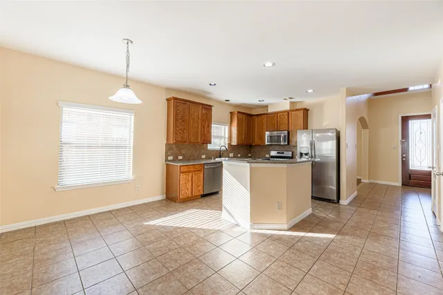 a kitchen with stainless steel appliances a refrigerator sink and cabinets
