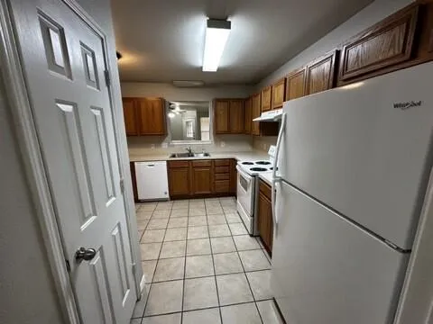 a kitchen with stainless steel appliances a refrigerator sink and stove