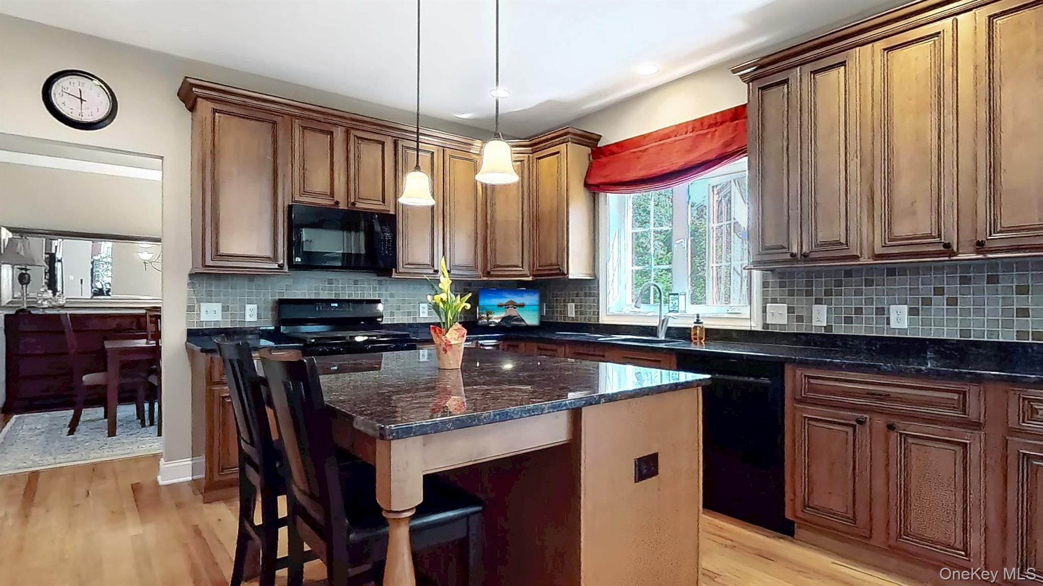 28 Madison Court Wallkill, NY 12589 - Photo 14 of 44 a kitchen with stainless steel appliances granite countertop a stove a sink dishwasher a microwave oven with granite countertops and cabinets