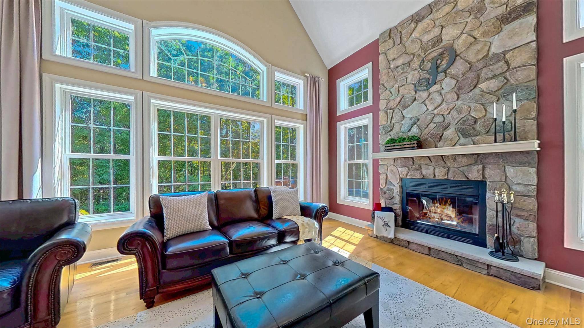 28 Madison Court Wallkill, NY 12589 - Photo 20 of 44 a living room with furniture a floor to ceiling windows and a fireplace