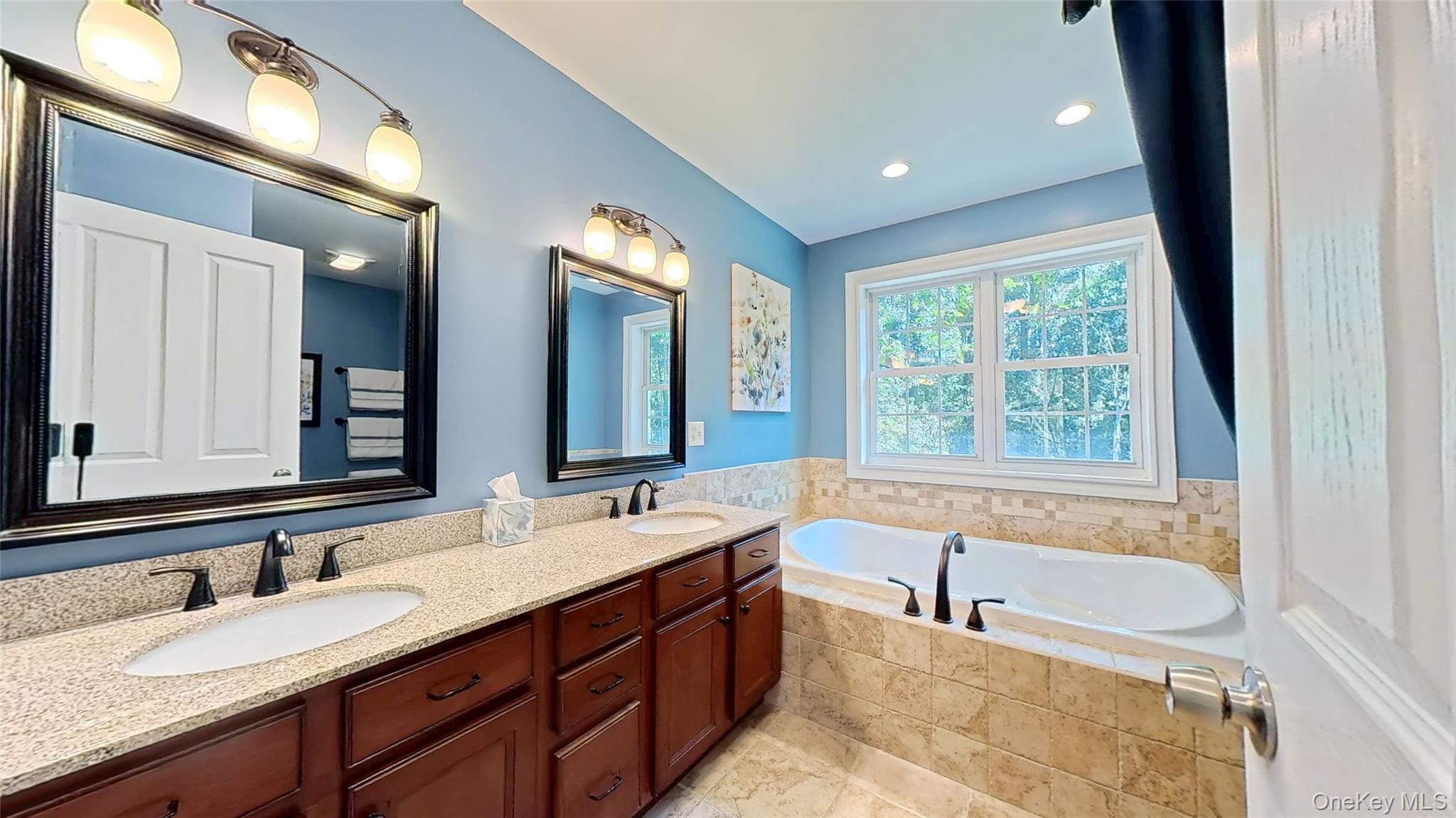 28 Madison Court Wallkill, NY 12589 - Photo 28 of 44 a bathroom with a granite countertop tub sink and mirror