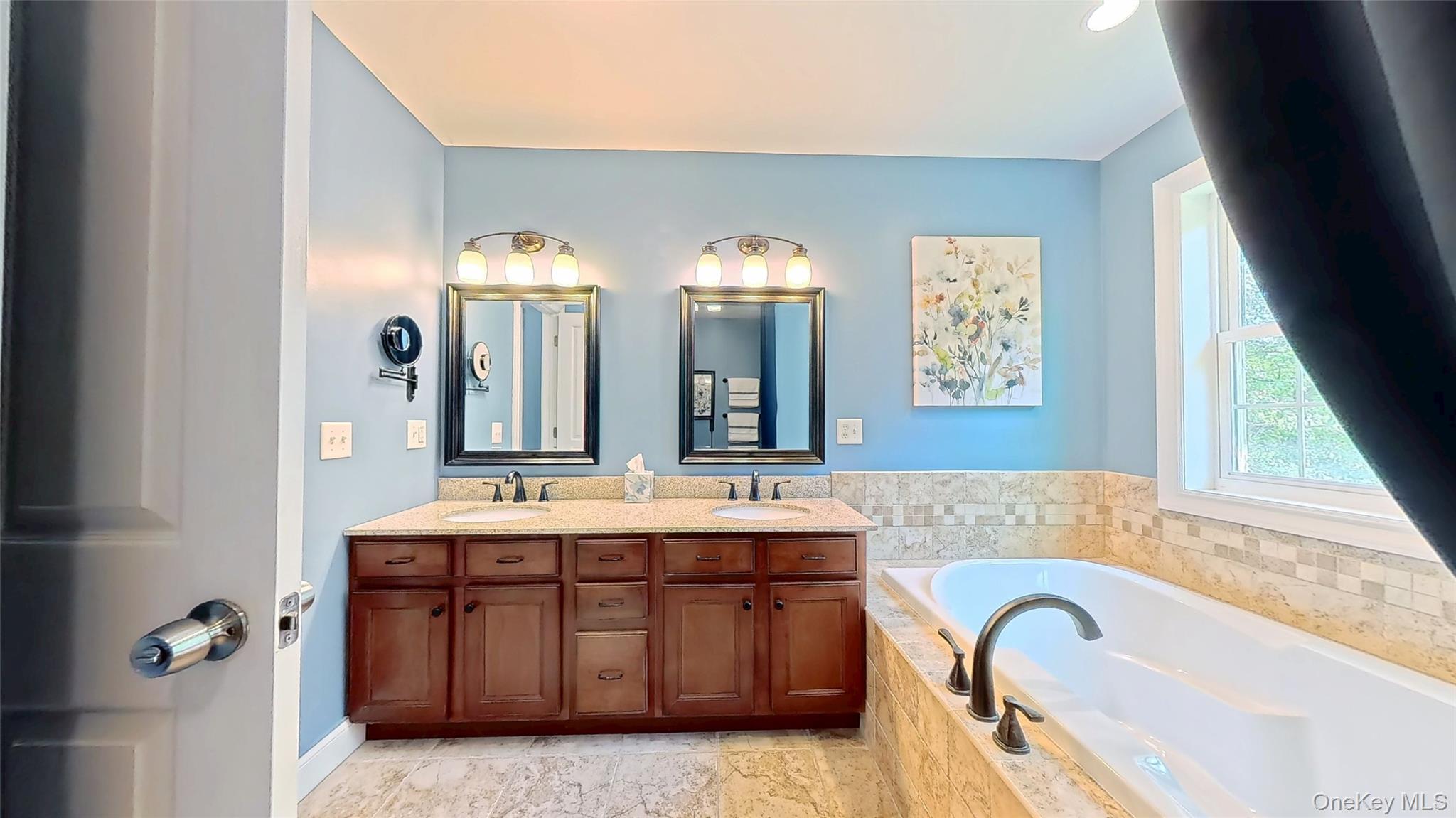 28 Madison Court Wallkill, NY 12589 - Photo 30 of 44 a bathroom with a granite countertop sink a mirror and a bathtub