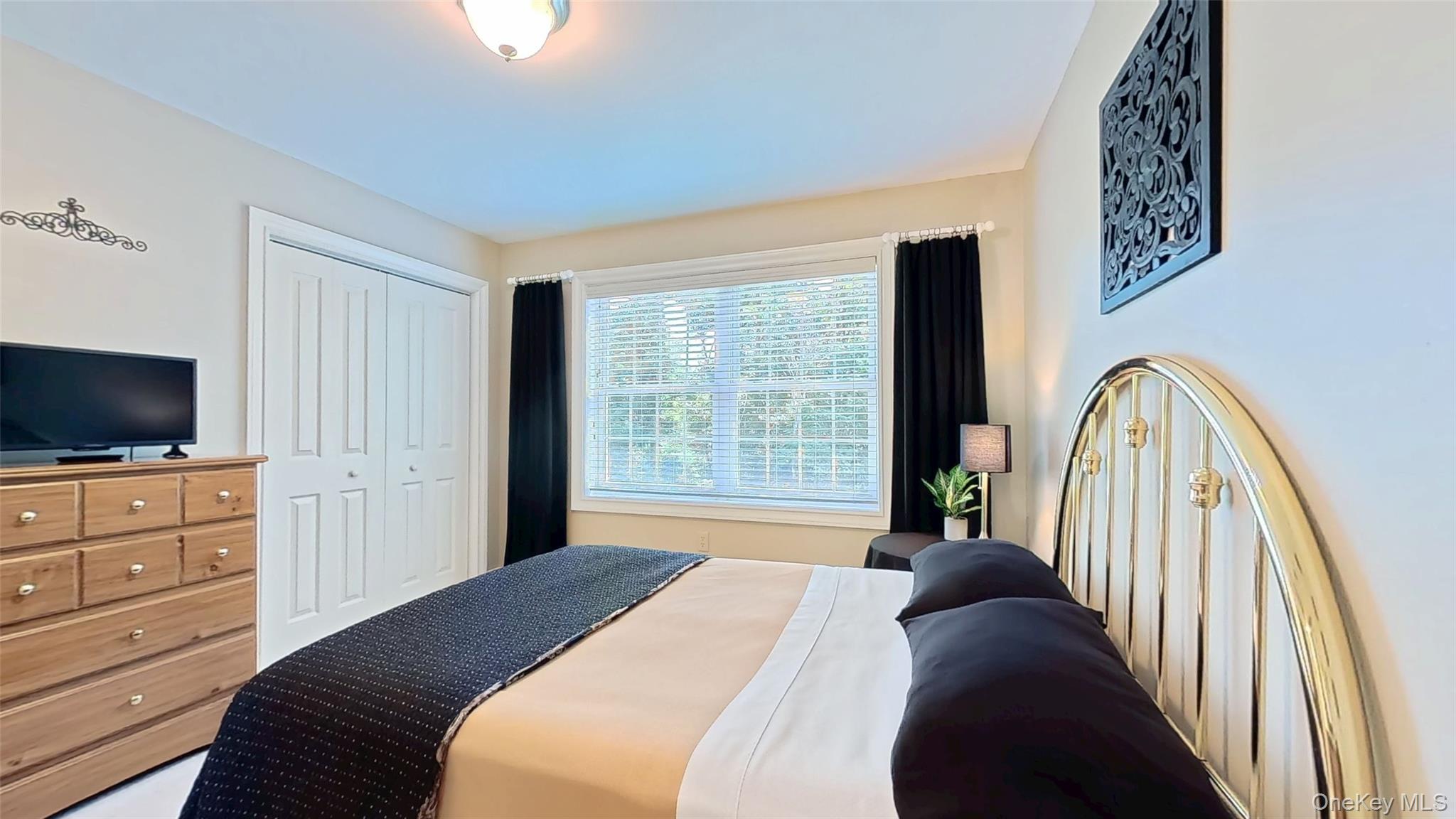 28 Madison Court Wallkill, NY 12589 - Photo 33 of 44 a bedroom with a bed and a flat screen tv