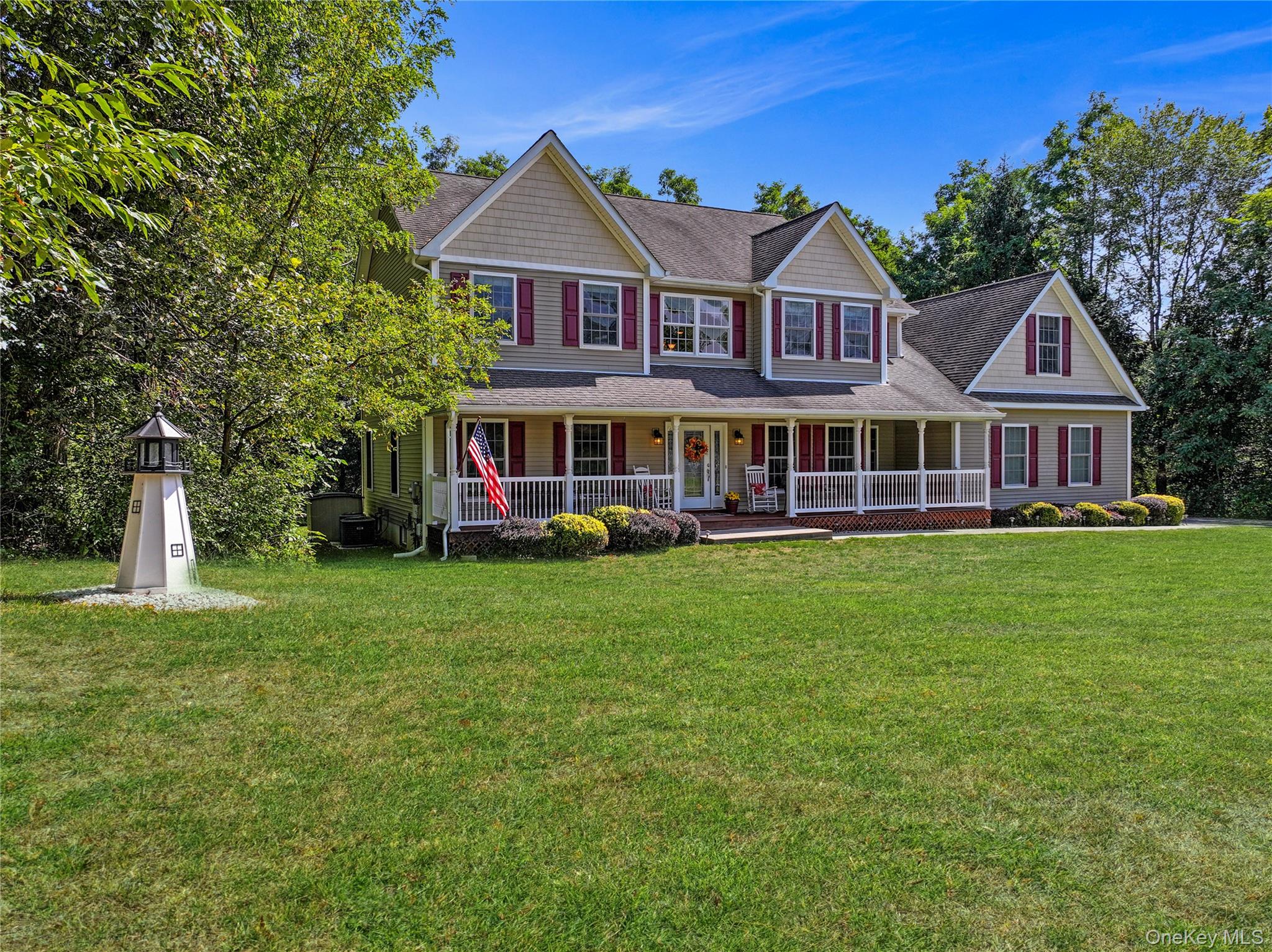 28 Madison Court Wallkill, NY 12589 - Photo 42 of 44 a front view of a house with a yard table and chairs