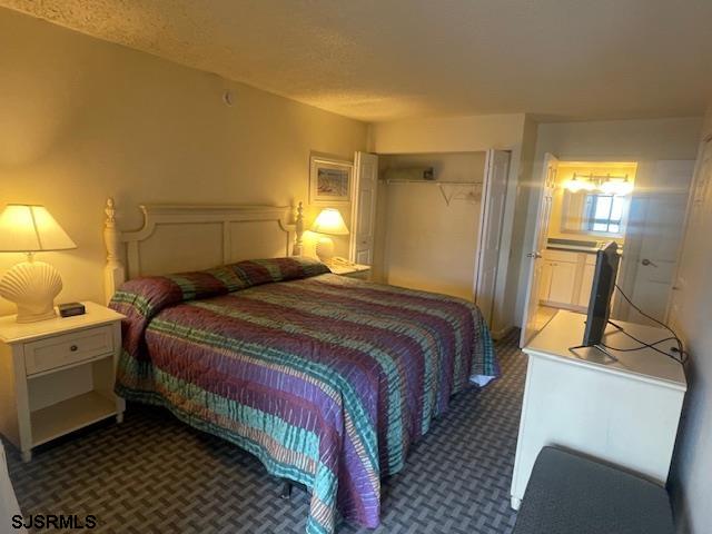 4500 West Brigantine Avenue, Unit 2216 Brigantine, NJ 08203 - Photo 13 of 14 a bedroom with a bed and a mirror