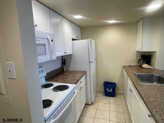 4500 West Brigantine Avenue, Unit 2216 Brigantine, NJ 08203 - Photo 3 of 14 a kitchen with a sink a stove and refrigerator