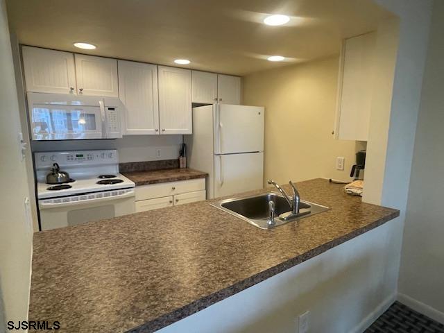 4500 West Brigantine Avenue, Unit 2216 Brigantine, NJ 08203 - Photo 4 of 14 a kitchen with kitchen island granite countertop a sink a stove and refrigerator