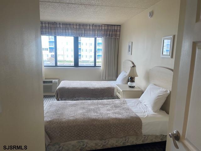 4500 West Brigantine Avenue, Unit 2216 Brigantine, NJ 08203 - Photo 8 of 14 a bed sitting in a bedroom next to a window