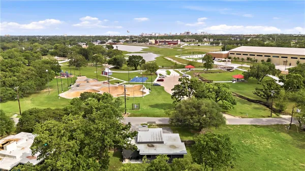 an aerial view of residential houses with outdoor space and ocean view