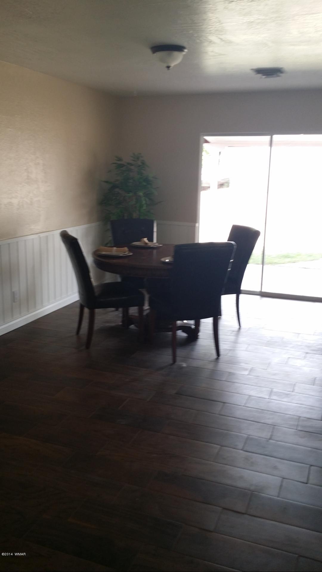 830 Cattle Lane Taylor, AZ 85939 - Photo 5 of 8 a view of a dining room with furniture and wooden floor