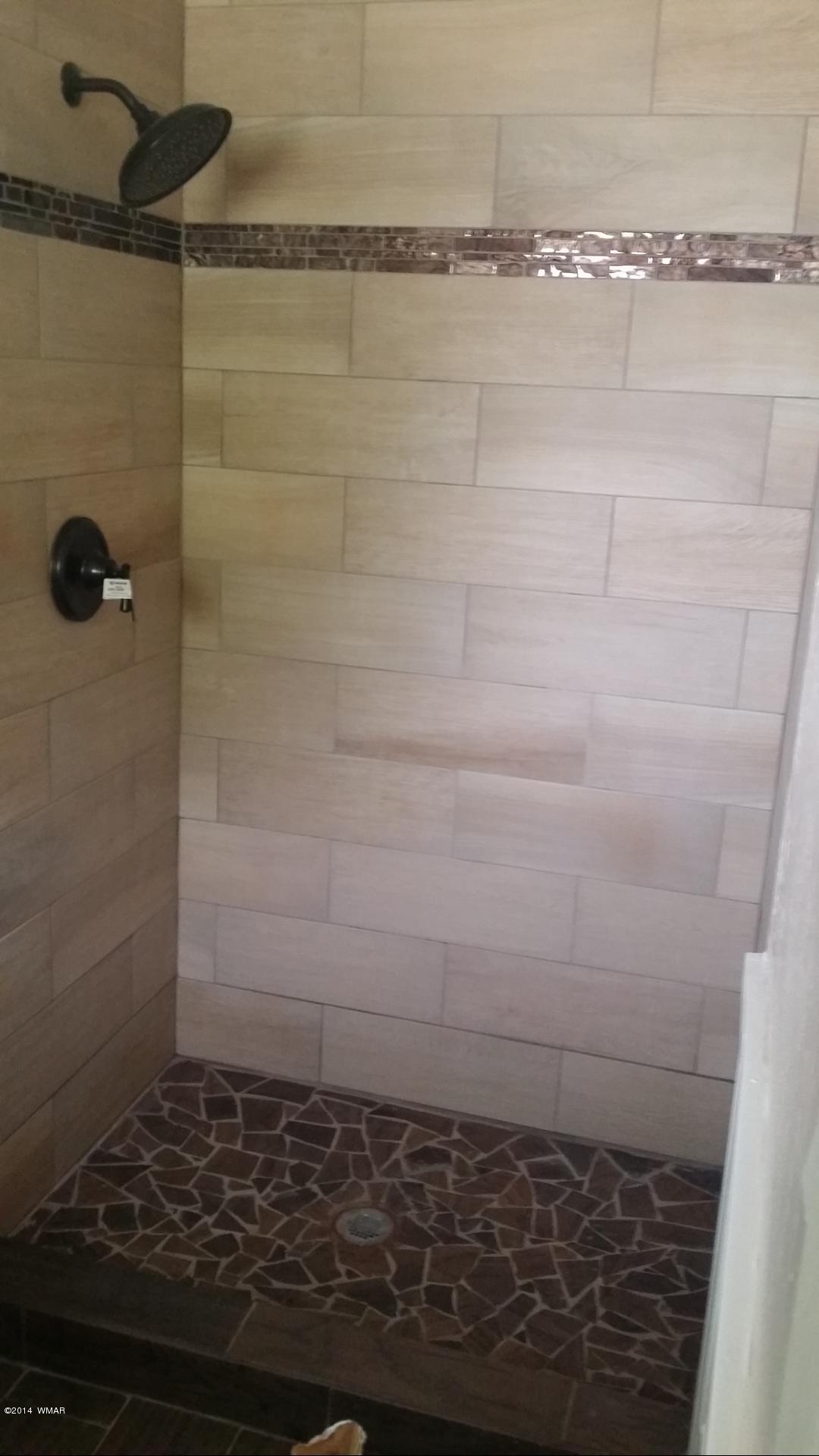 830 Cattle Lane Taylor, AZ 85939 - Photo 8 of 8 a bathroom with a shower