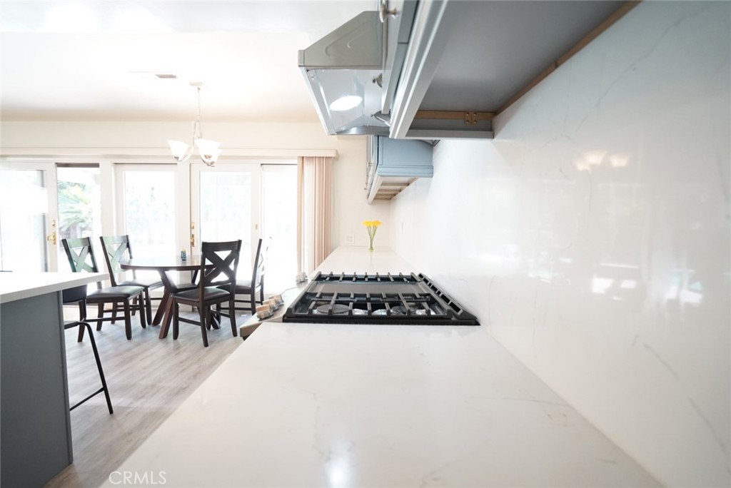 1925 El Sereno Avenue Arcadia, CA 91007 - Photo 10 of 37 a kitchen with stainless steel appliances a stove a table and chairs