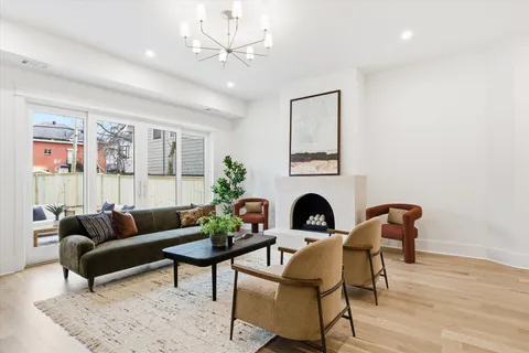 a spacious bedroom with a bed and a chandelier
