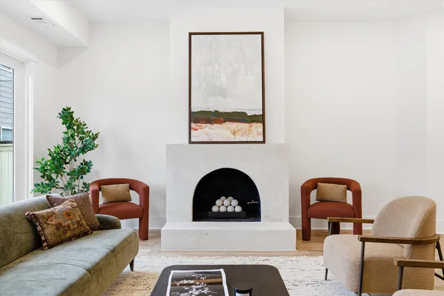 a spacious bedroom with a bed and a chandelier