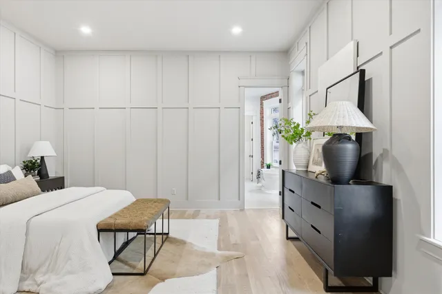 a view of an empty room with wooden floor and closet