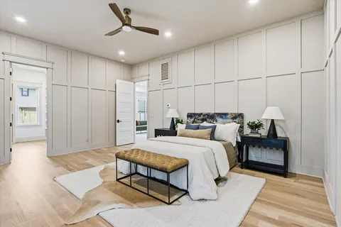 a view of a hallway with wooden floor and a living room