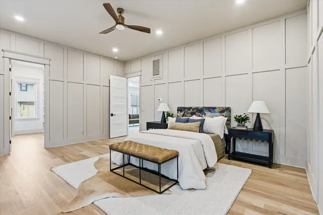 a view of a hallway with wooden floor and a living room