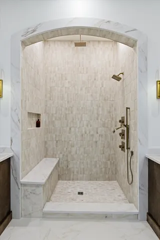 a living room with furniture a couch and a potted plant