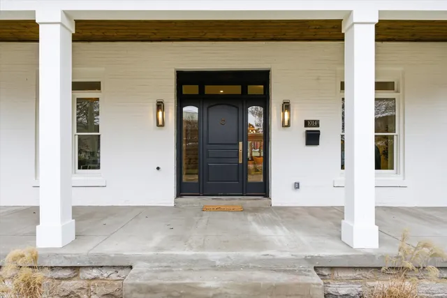 a view of a workspace with a table and a potted plant
