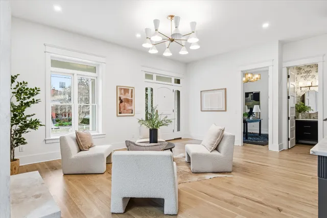 a kitchen with stainless steel appliances kitchen island granite countertop a sink a stove and a wooden floors
