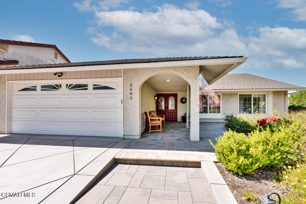 a view of a house with barbeque grill and plants