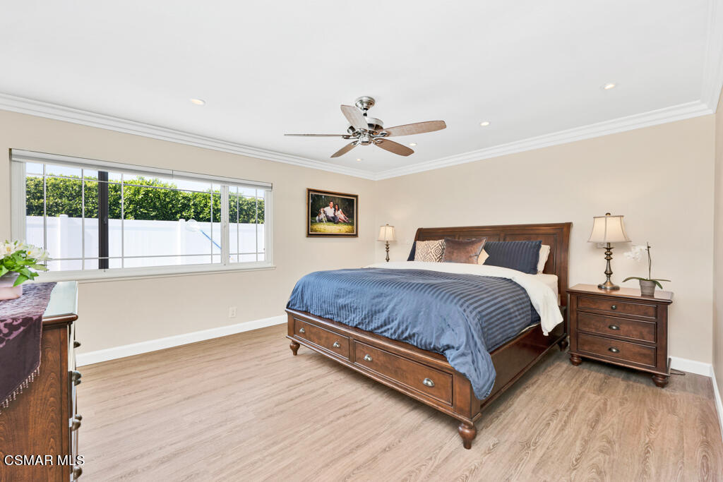 2685 Velarde Drive Thousand Oaks, CA 91360 - Photo 21 of 40 a bedroom with a large bed and a chandelier