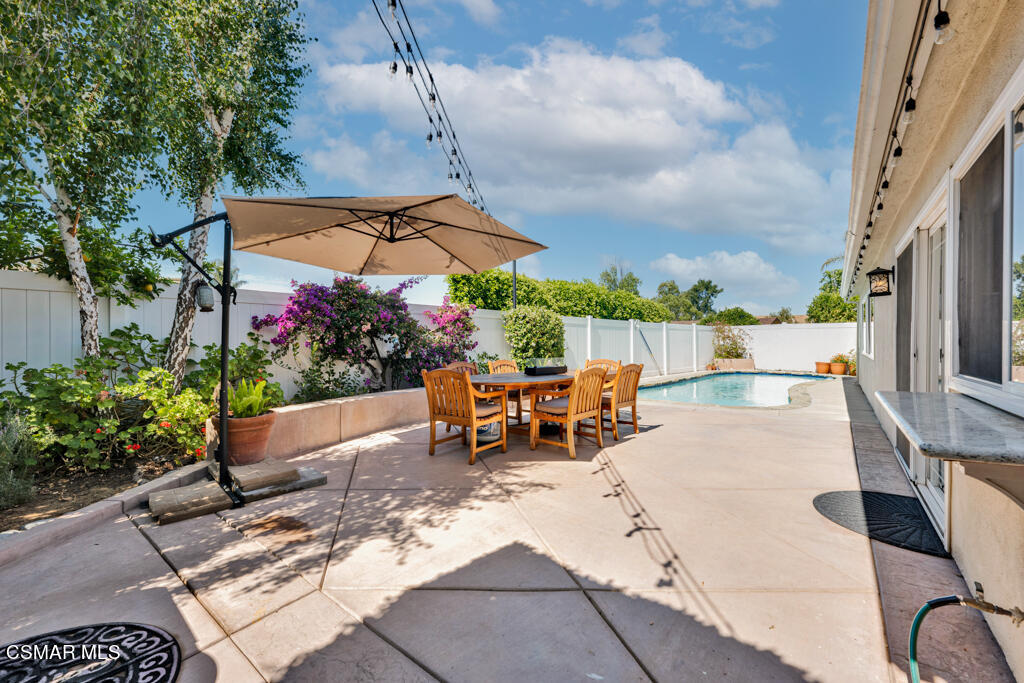 2685 Velarde Drive Thousand Oaks, CA 91360 - Photo 25 of 40 a view of a patio with a table and chairs under an umbrella
