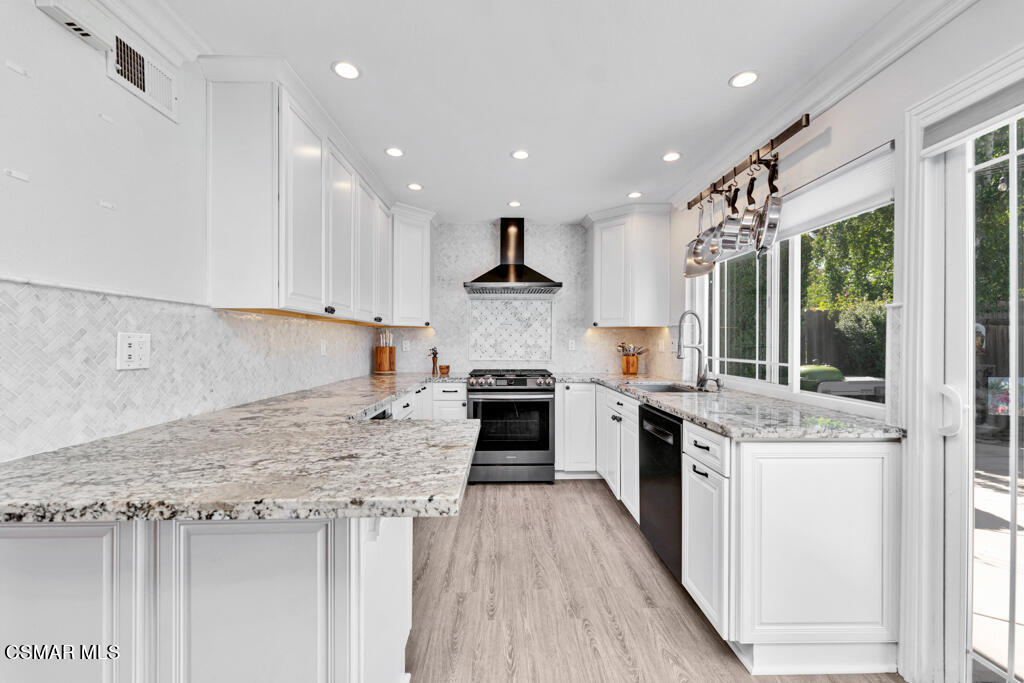 2685 Velarde Drive Thousand Oaks, CA 91360 - Photo 10 of 40 a kitchen with stainless steel appliances granite countertop a stove top oven a sink dishwasher and a refrigerator with wooden floor