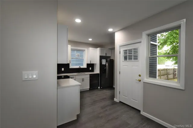 a kitchen with a refrigerator and a stove top oven