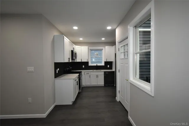 a kitchen with a refrigerator and a sink