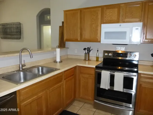a living room with furniture and kitchen view