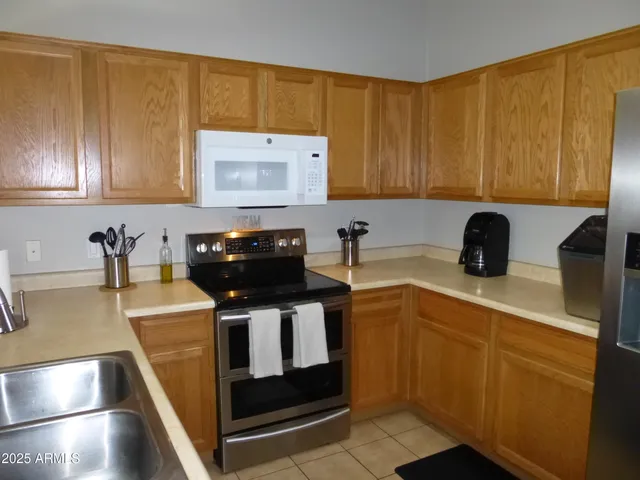 a kitchen with sink a microwave and stove