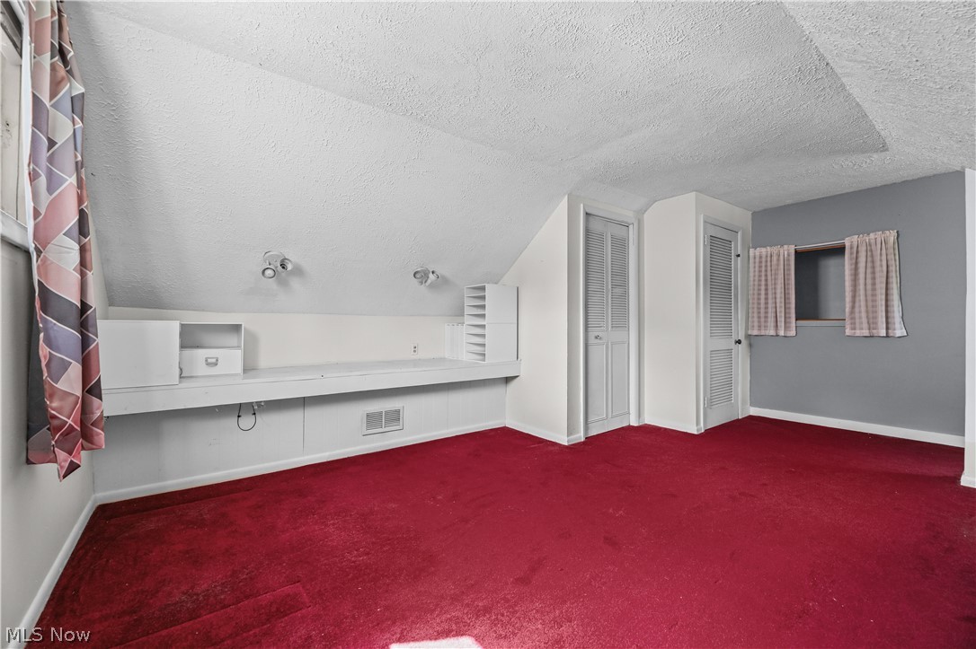 150 Graham Road Cuyahoga Falls, OH 44223 - Photo 19 of 38 Room featuring crimson carpeting and an angled ceiling line