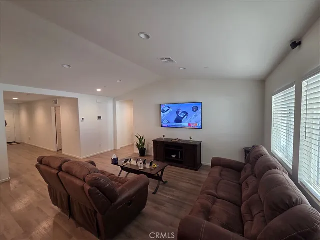 a living room with furniture a couch and a window